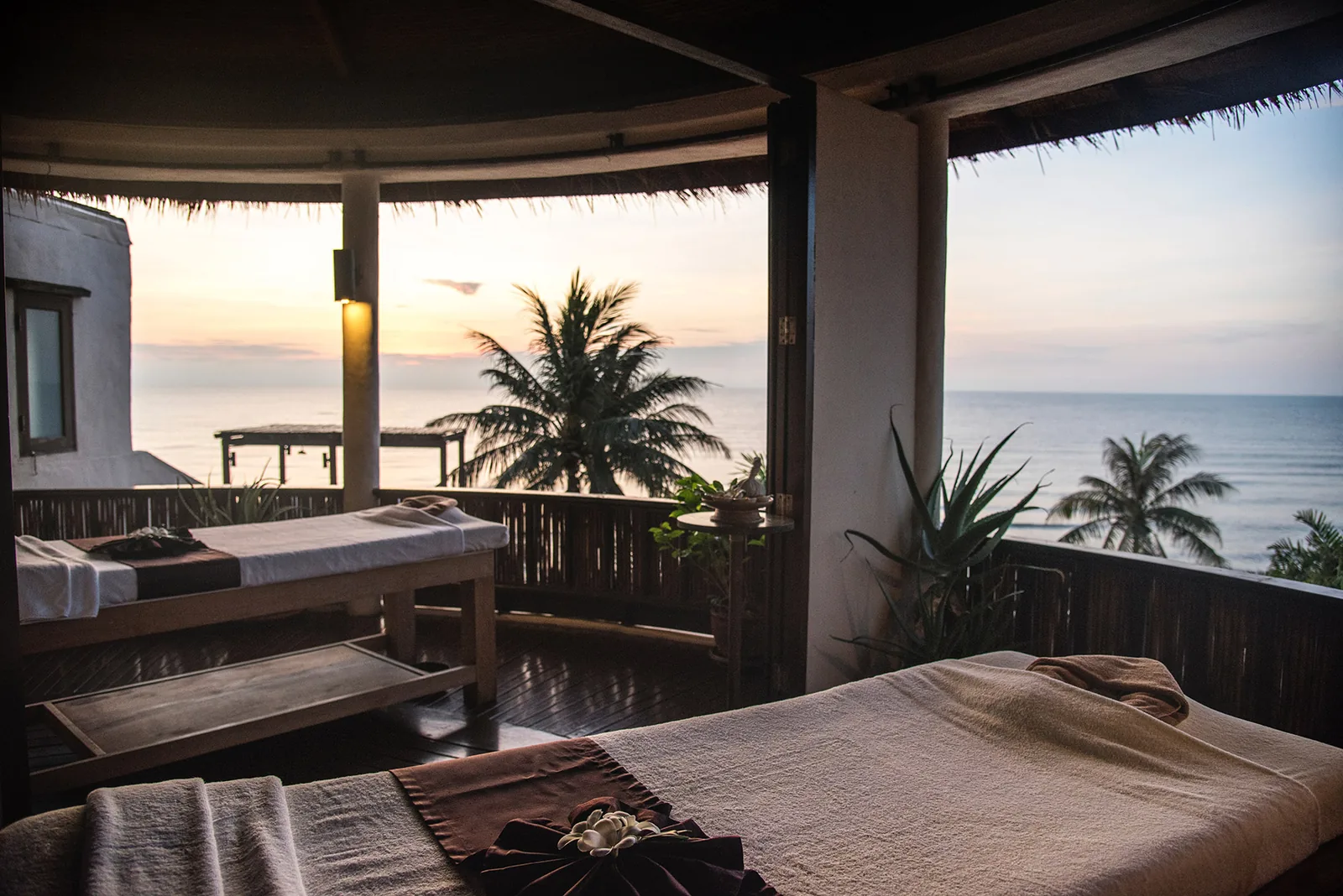 Ocean-view spa treatment room at sunset