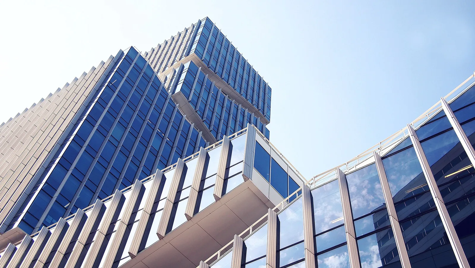 Glass skyscraper viewed from below against a clear sky